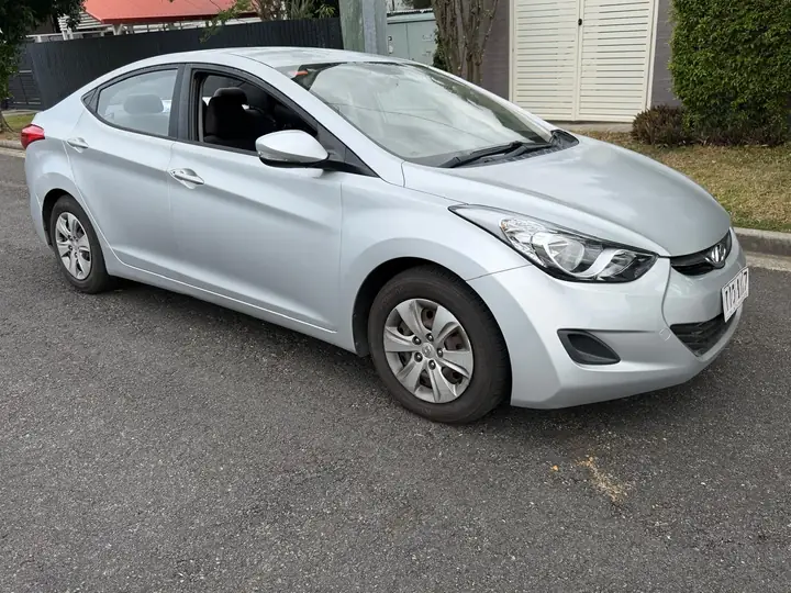 Front three-quarter view of the silver 2013 Hyundai Elantra