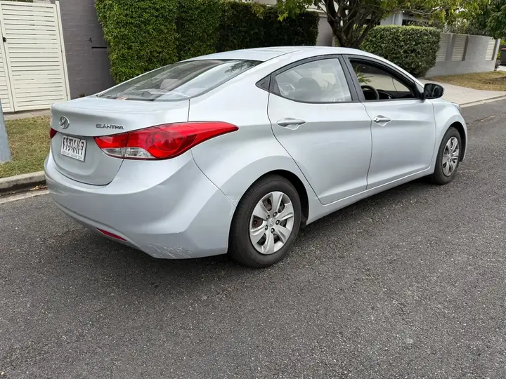 Rear three-quarter view of the silver 2013 Hyundai Elantra