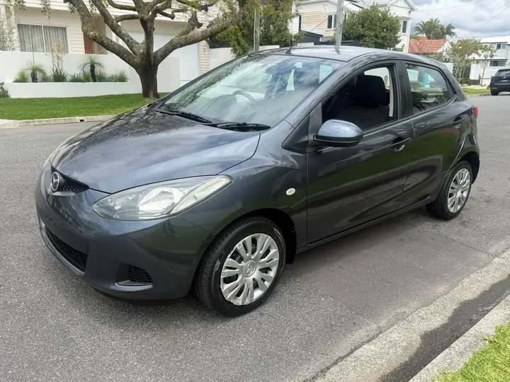 Front three-quarter view of the silver 2009 Mazda 2