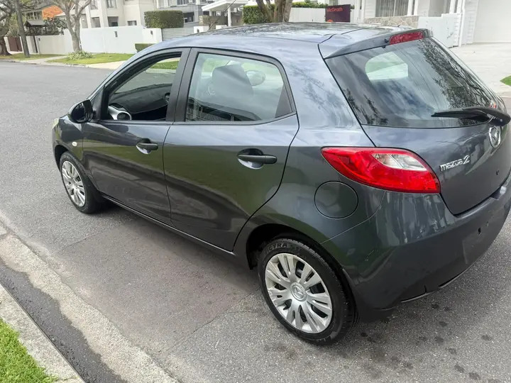 Rear three-quarter view of the silver 2009 Mazda 2