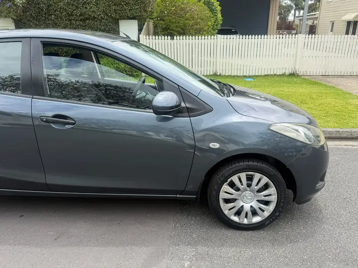 Left side of the silver 2009 Mazda 2